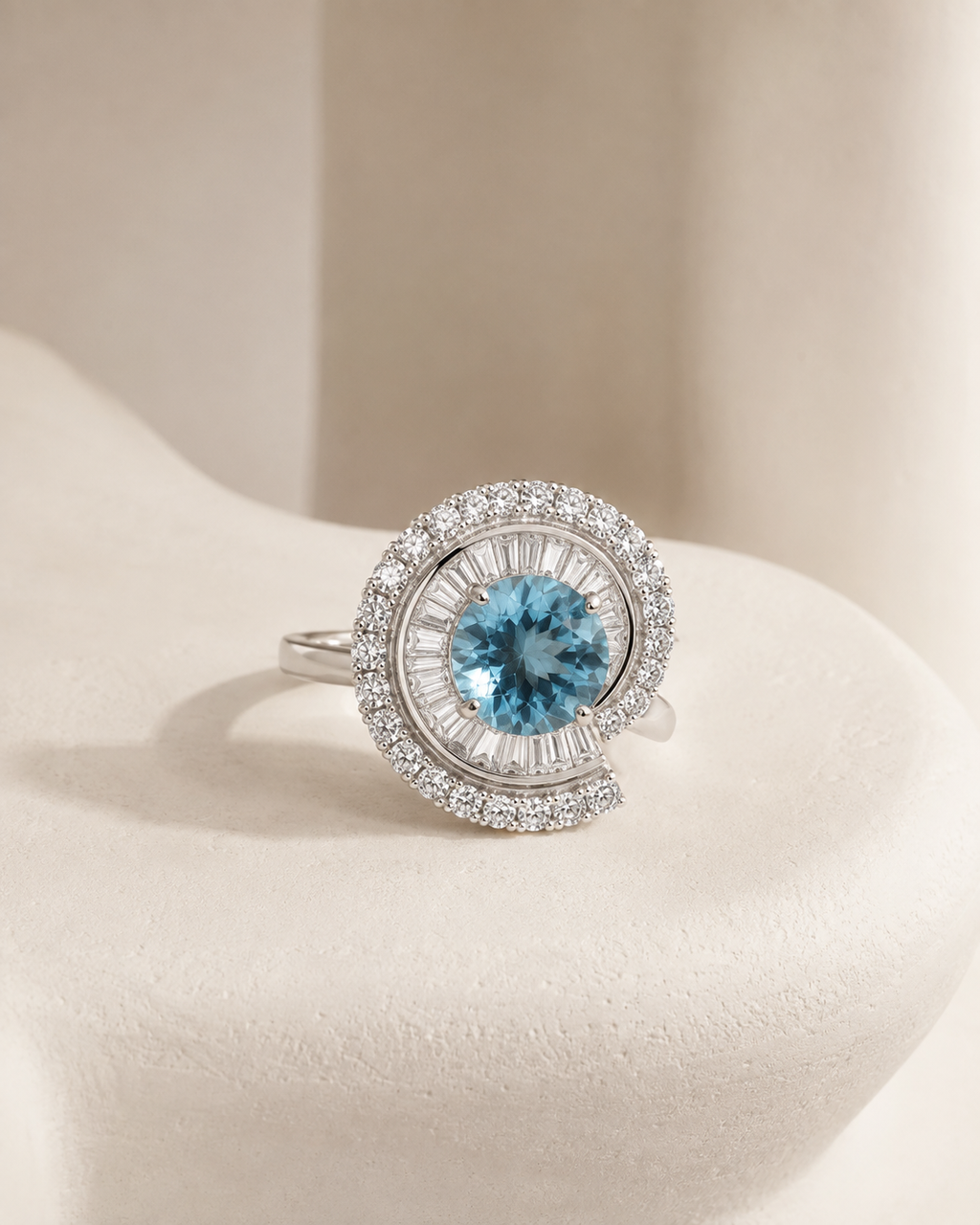 Azure Halo Ring resting on soft ivory stone