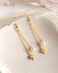 Starlight Pearl Dangle Earrings on ceramic dish